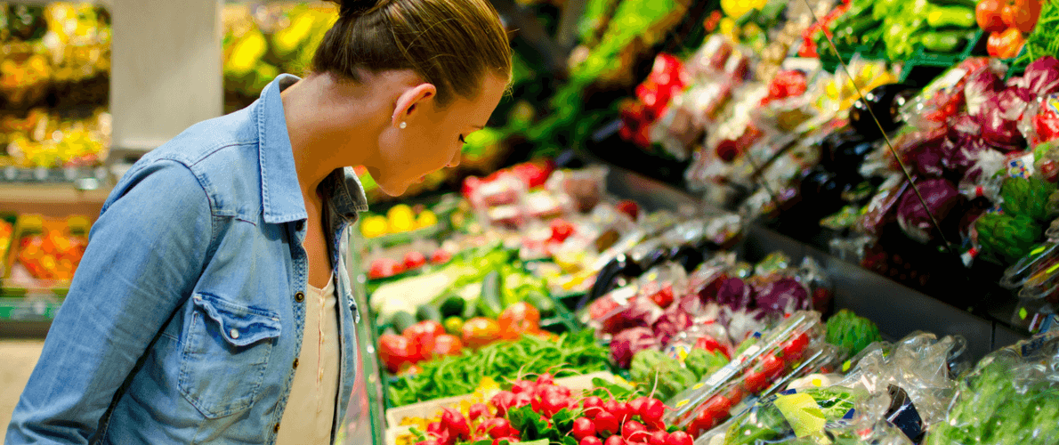 woman buying vegetables at grocery store